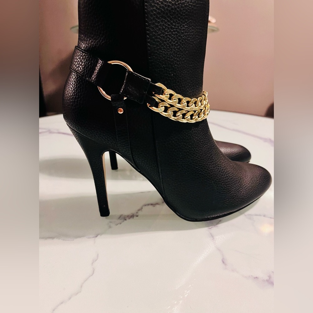 Black boots with gold chains and zipper at the sides